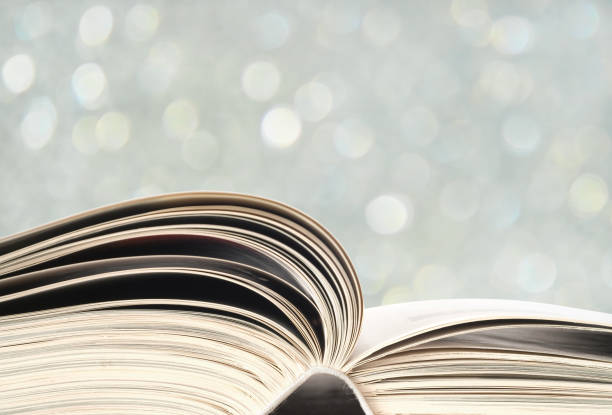 istock Open book, close up on blurry bubbles background. Reading,learning, education, concept 1204192360