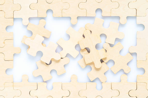 istock wooden jigsaw puzzle pieces on white background 1204192701