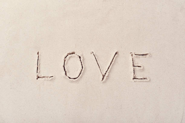 istock Inscription love on beach sand 1204196334