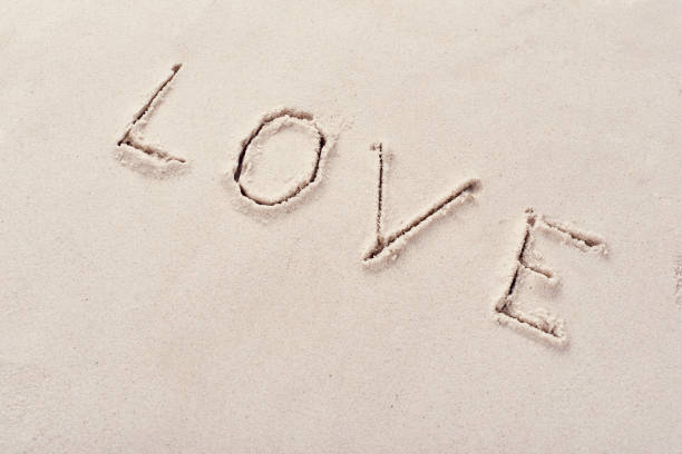 istock Inscription love on beach sand 1204196672