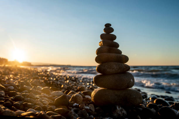 istock Pyramid of stones on the beach at sunset, 1204196981