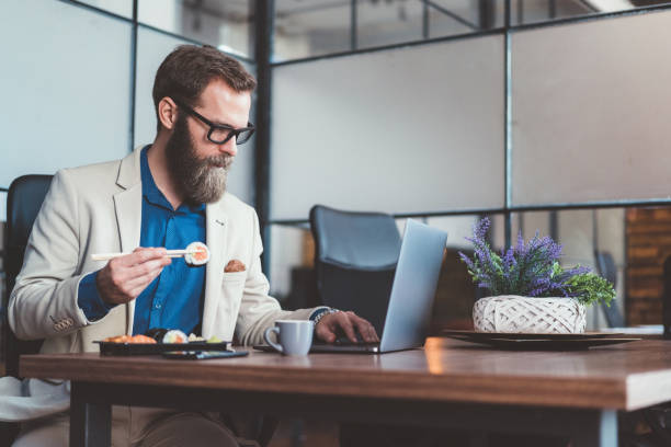 Businessman eating sushi in the office