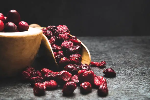 Red berries on a dark background. cranberries in a bowl