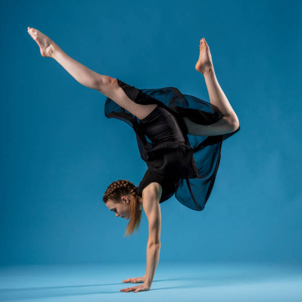 istock Rhythmic gymnast in black dress exercising 1204200386