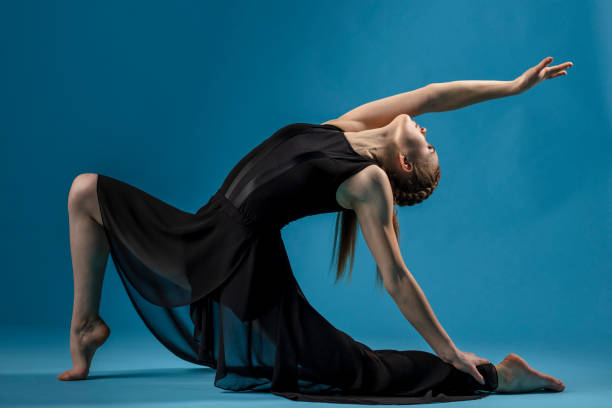 istock Rhythmic gymnast in black dress exercising 1204200388