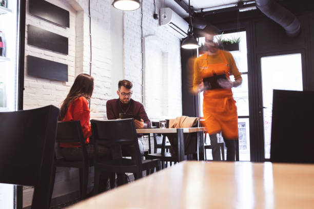 istock Waiter Takes Order From a young Couple 1204200692