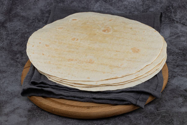 istock Stack of corn tortillas on dark background. Mexican food 1204200845