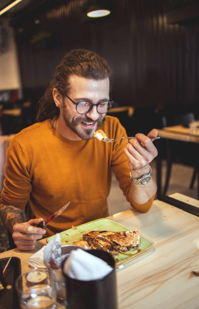 istock Young man in Fast Food Restaurant 1204201032