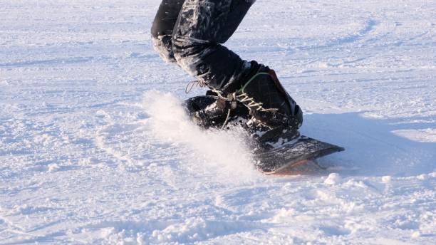 istock snowboarder jumping on a snowboard, close-up, snowboarder feet 1204201248