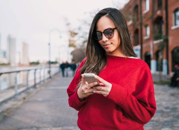 istock Young woman using her mobile phone. 1204205717