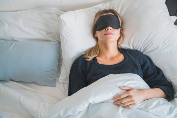 istock Woman sleeping with sleep mask. 1204206480