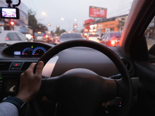 istock hand's man driver holding car steering wheel on the traffic road 1204208235