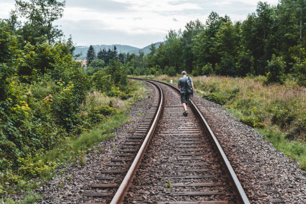 istock Tourist hiking on the railway tracks 1204212079