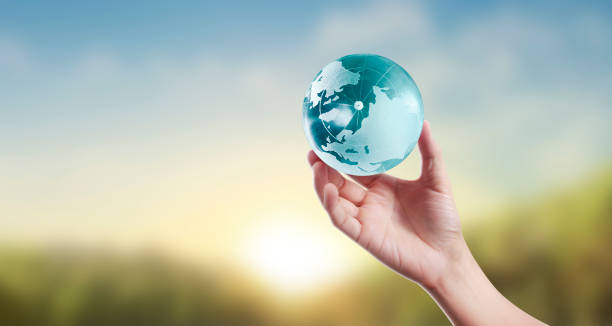 istock Globe ,earth in human hand, holding our planet glowing 1204214539