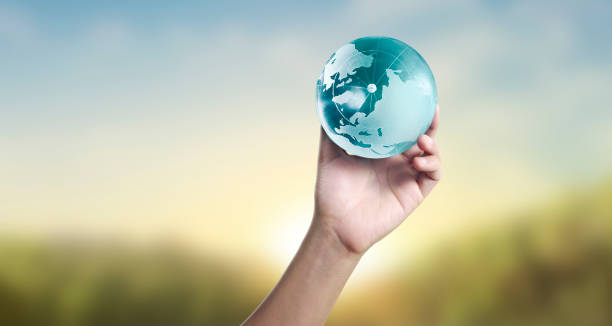istock Globe ,earth in human hand, holding our planet glowing 1204214548