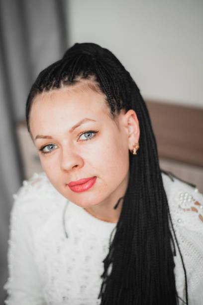 istock Beautiful girl with black Afro-pigtails on a plain background 1204215048