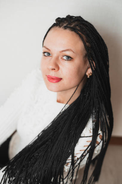istock Beautiful girl with black Afro-pigtails on a plain background 1204215521