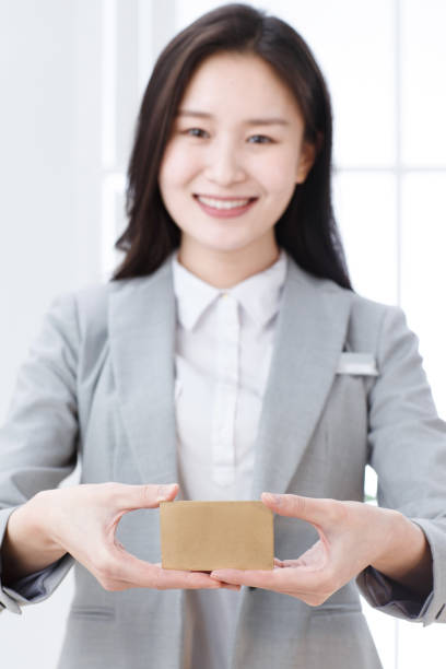 istock Business young woman with a card 1204219992