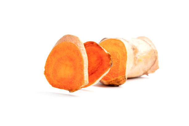 Cutting of turmeric curcumin root on isolated white background.