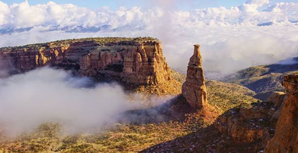 A Cloud/Fog Inversion Creeping into a Valley in the Colorado National Monument (Independence Rock) in the Grand Valley of Western Colorado A Cloud/Fog Inversion Creeping into a Valley in the Colorado National Monument (Independence Rock) in the Grand Valley of Western Colorado fruita colorado stock pictures, royalty-free photos & images