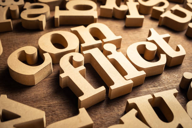 Conflict Word CONFLICT word by wood alphabets with many random letters around morality photos stock pictures, royalty-free photos & images