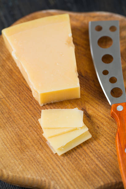 istock cheese knife with a wooden handle over black 1204223511