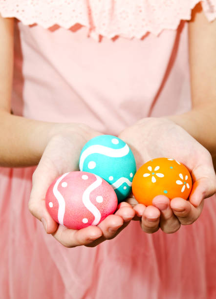 istock Little girl holding handmade painted easter eggs 1204223567