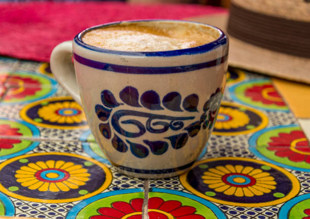 istock Rustic pottery on colourful table in cafe with straw hat in Mexico City 1204225903