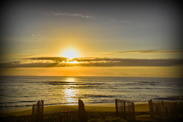 istock Sun shining through the clouds and reflecting off the gentle ocean waves 1204229339