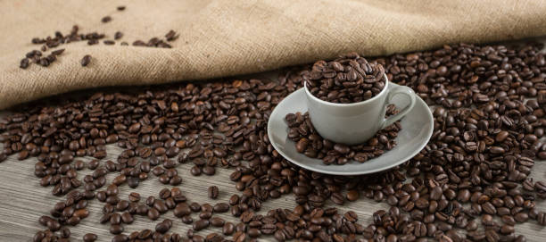 istock Roasted coffee beans in a coffee mug 1204229389