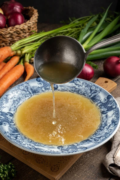 istock Pouring chicken bone broth into a vintage plate 1204230734