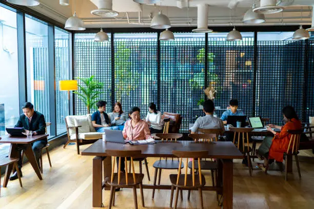 Photo of Asians Millennials busy working in co-working space.