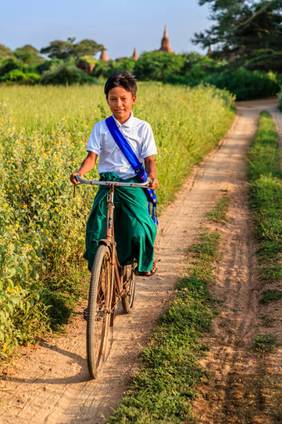 istock Burmese schoolboy riding a bicycle in Bagan, Myanmar 1204233459