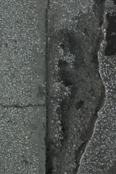 istock Concrete floor covering with cracks and inclusions 1204234106