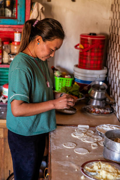 istock Tibetan woman preparing making momos, Upper Mustang, Nepal 1204234622