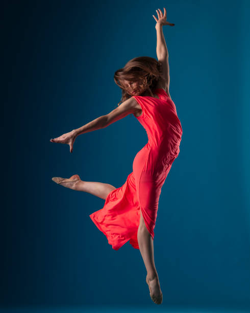 istock Dancer in red dress on blue background 1204235926