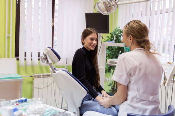 istock Friendly female dentist with patient 1204237844