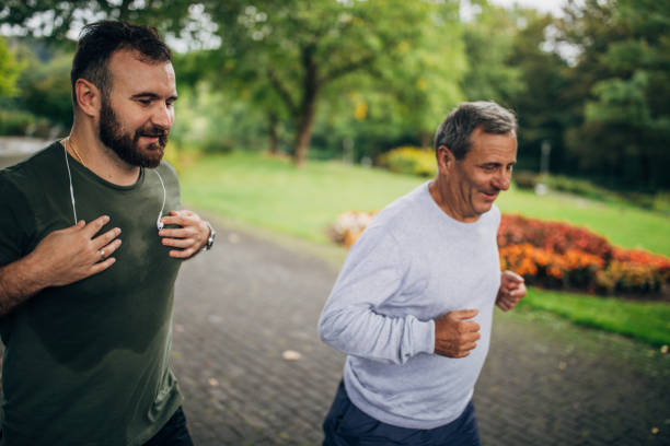 istock Father and son jogging in park 1204240601