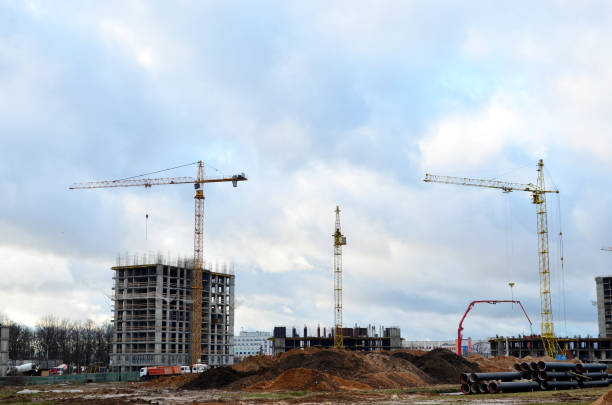 istock Tower cranes constructing a new residential building at a construction site 1204241387