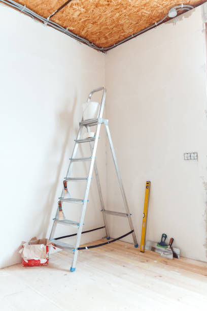 istock A stepladder with painting tools in a room. Preparing for putty 1204242313