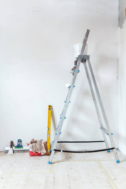 istock A stepladder with painting tools in a room. Preparing for putty 1204242849