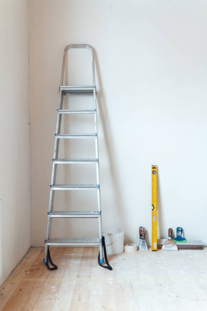 istock A stepladder with painting tools in a room. Preparing for putty 1204242863