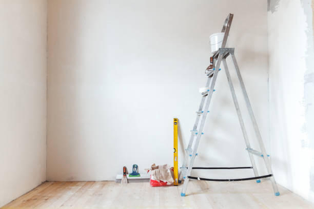 istock A stepladder with painting tools in a room. Preparing for putty 1204243429