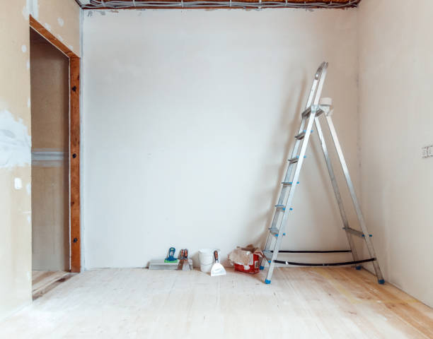 istock A stepladder with painting tools in a room. Preparing for putty 1204243492