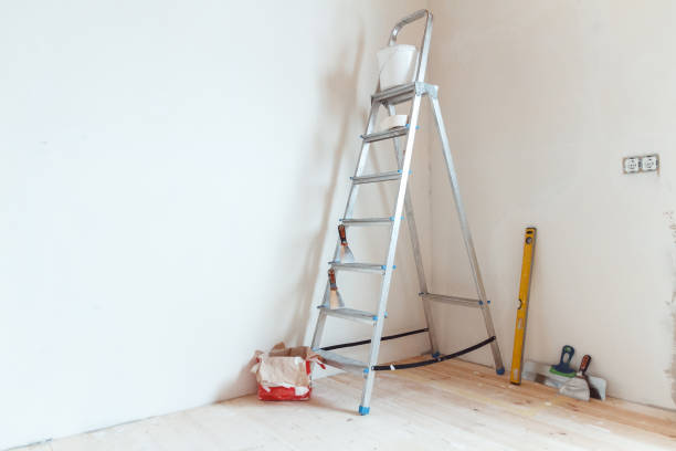 istock A stepladder with painting tools in a room. Preparing for putty 1204243779