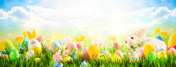 istock Easter eggs, bunny and spring flowers on meadow 1204244617
