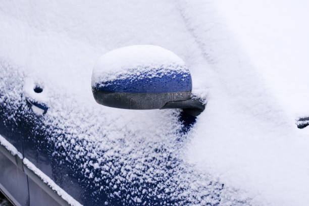 istock Snow covered car in an open parking 1204244992
