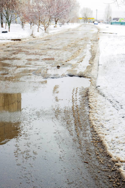 istock Paved road covered with melting snow 1204245025