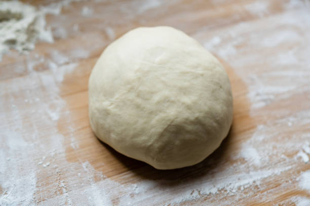 istock Preparetion dough of bread on the table 1204245045