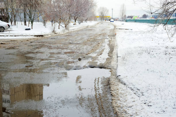 istock Paved road covered with melting snow 1204245065